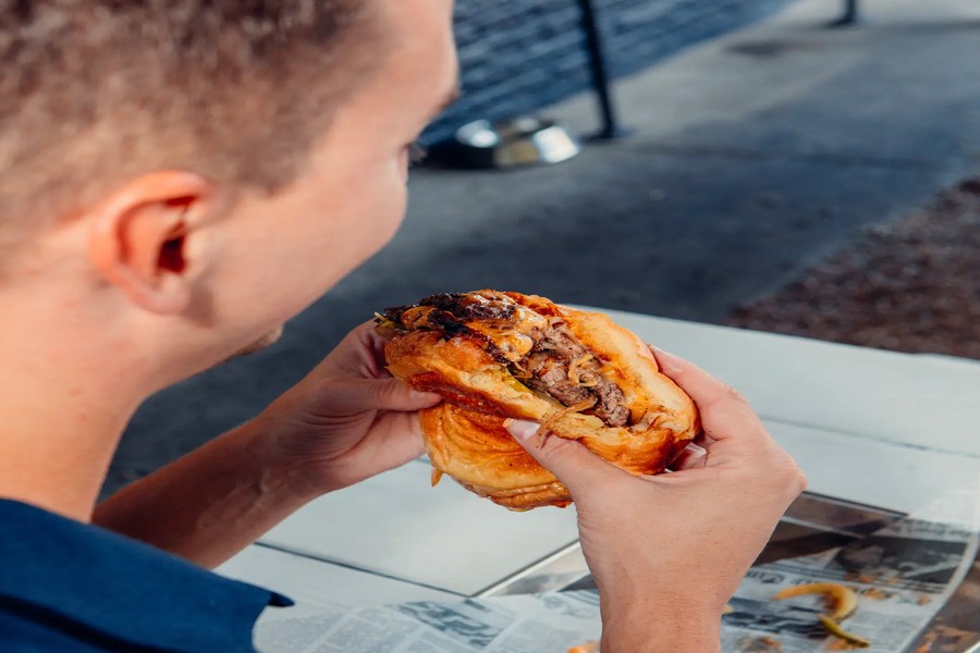 Cuban torta held in hand at Austin Daily Press
