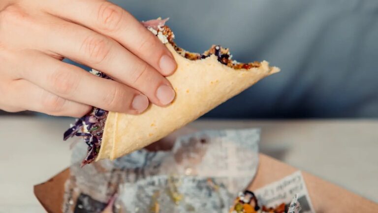 Taco in hand at Austin Daily Press in East Austin, Austin, TX